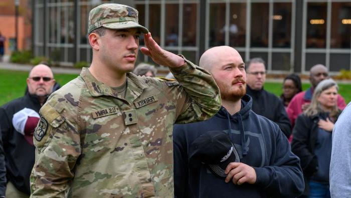 A veteran-student salutes during Veterans Day ceremony